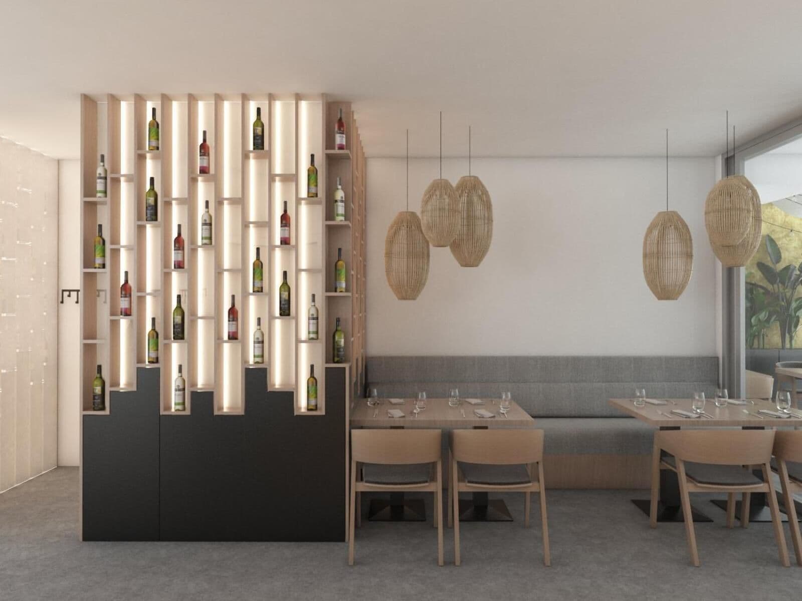 A modern dining area with a wine rack, wooden tables, and hanging wicker lamps.