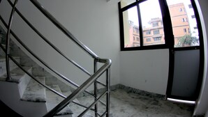 A staircase with metal railings leading to a landing.