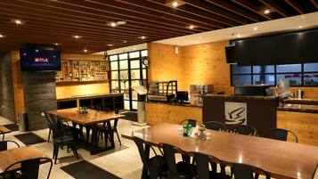 A restaurant with wooden walls, a bar area, and a television displaying 'NETFLIX'.