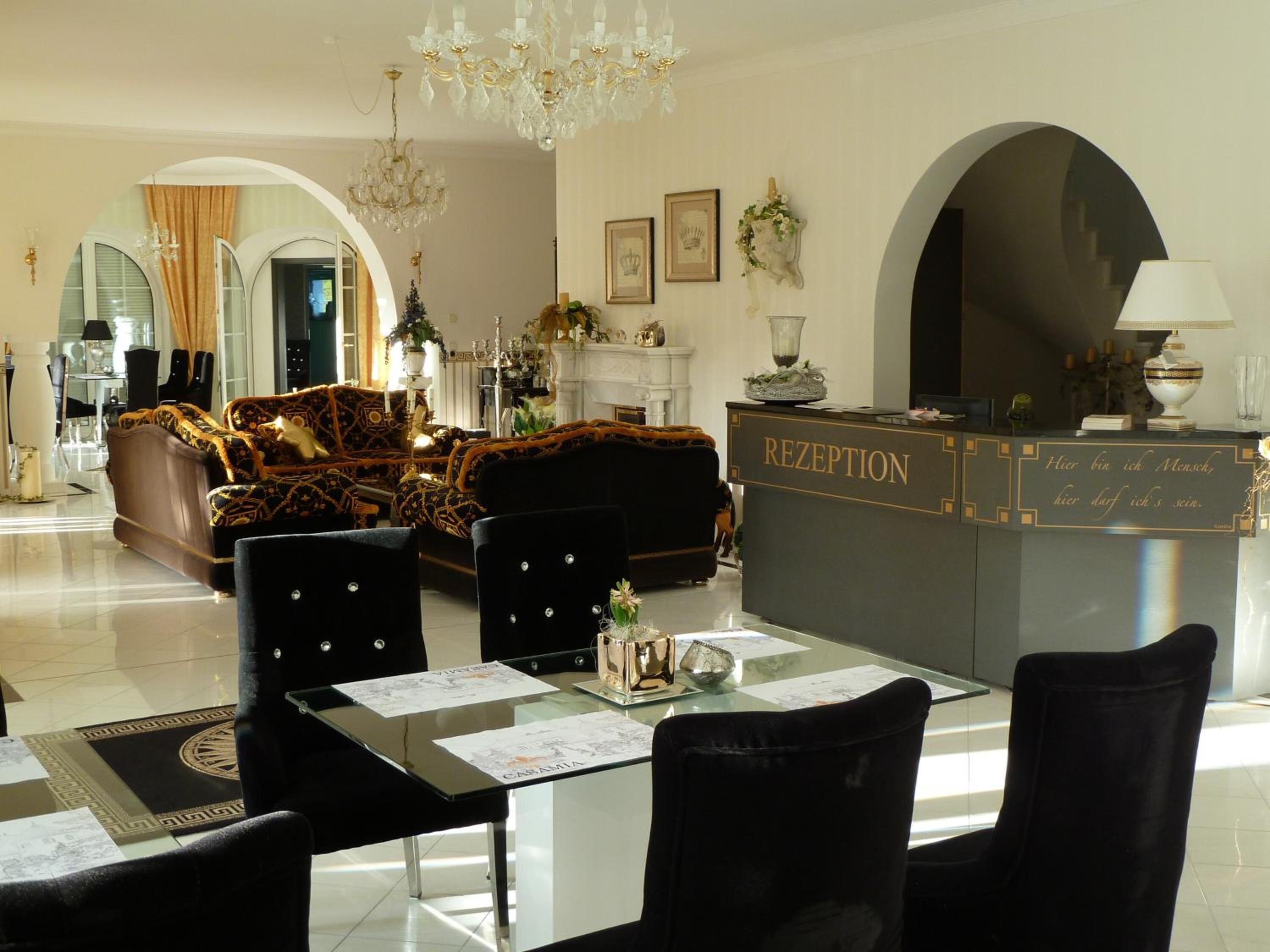 A luxurious reception area with a reception desk, elegant furniture, and decorative elements.