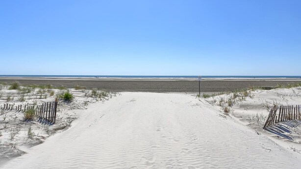 A sandy beach path leading to the ocean with a clear sky. - Ala Kai Motel (Wildwood Crest)