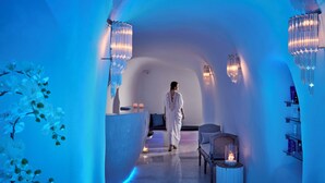 A spa-like interior with a central reception desk, seating area, and ambient lighting.
