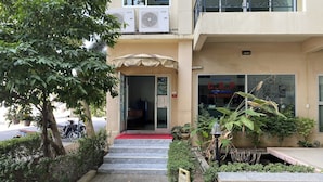 A building entrance with a red carpet, steps leading up to it, and a signboard. - C.a.p. Mansion Hotel (Wichit)
