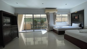 A hotel room with a large bed, a TV, a wardrobe, and a balcony with a view. - C.a.p. Mansion Hotel (Wichit)