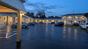 A motel with multiple rooms, a parking lot, and a covered walkway.