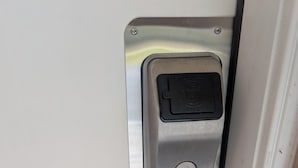 A metallic door handle with a keyhole and a lock mechanism.
