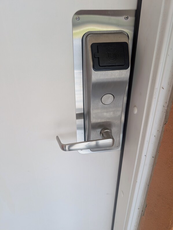 A metallic door handle with a keyhole and a lock mechanism.