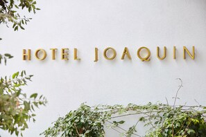 A wall with the text "HOTEL JOAQUIN" in gold letters. - Hotel Joaquin (Laguna Beach)