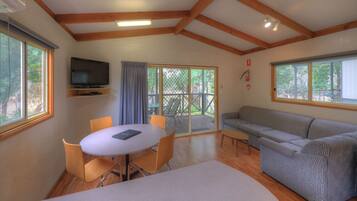 Riverfront Deluxe Cabin - 5 Berth | Living area | Flat-screen TV, DVD player