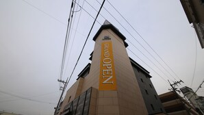 A building with a prominent 'GRAND OPEN' sign on its facade. - Avenue Hotel (Jeonju)