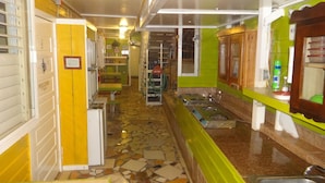 A kitchen with a tiled floor, a sink, and a countertop. - Cocopele Inn (San Ignacio)