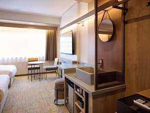 A hotel room with a bed, a desk, a chair, a small table, a sink, a mirror, and a trash bin. - JR WEST GROUP VIA INN SHINAGAWA OIMACHI (Tokyo)