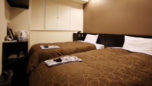 A hotel room with two beds, a minibar, a wardrobe, and a wall-mounted television. - Az Inn Higashiomi Notogawa Ekimae (Higashiomi)