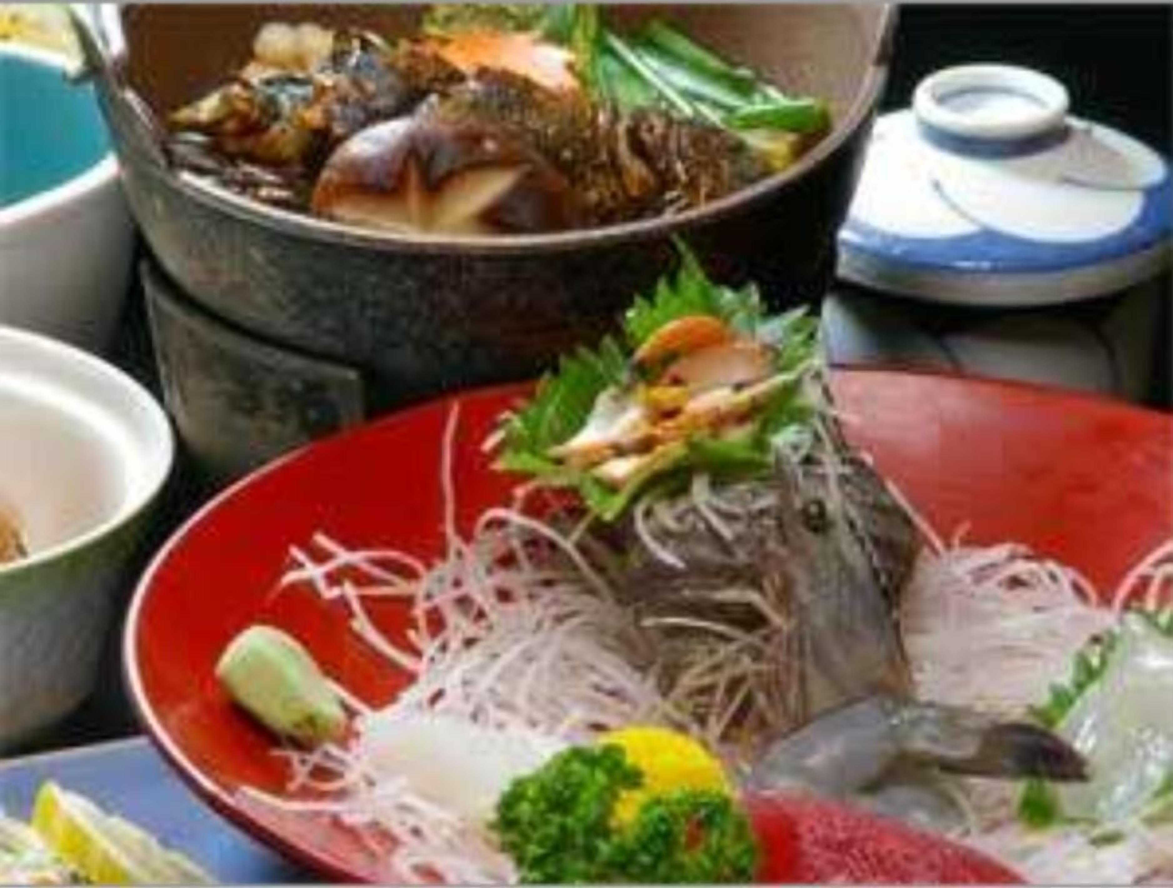 A variety of dishes including seafood and vegetables, suggesting a restaurant setting.