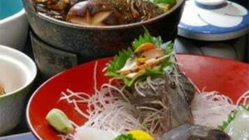 A variety of dishes including seafood and vegetables, suggesting a restaurant setting.