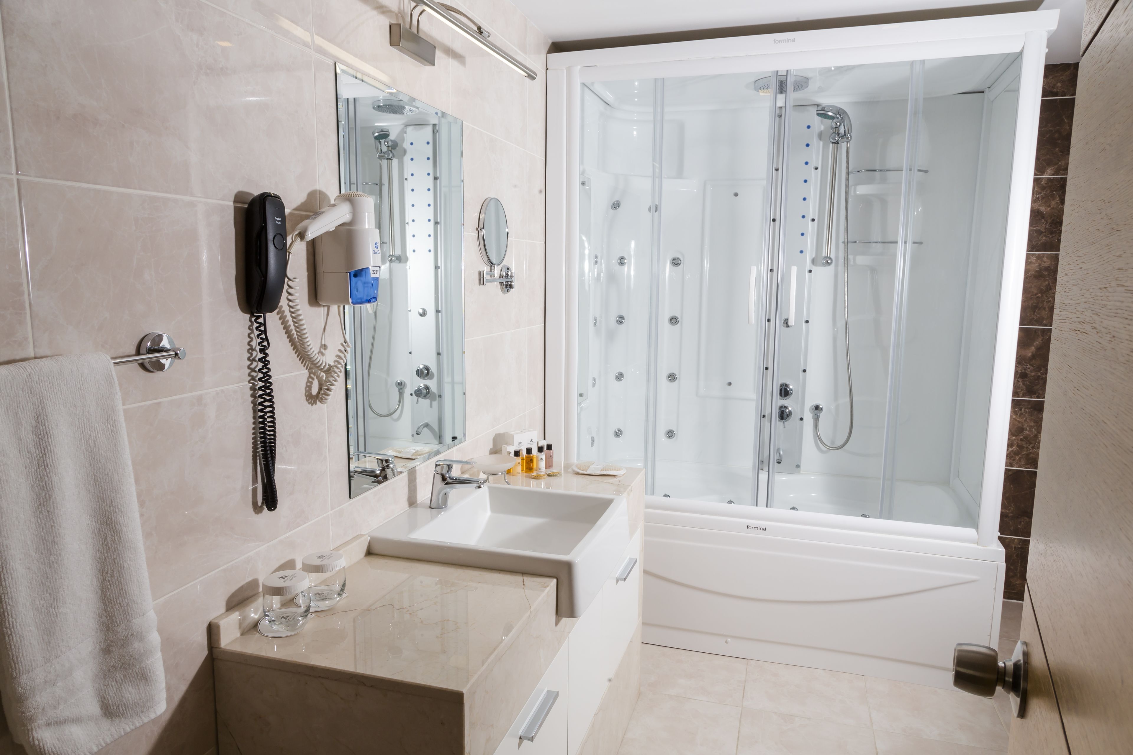 comfort suite | bathroom | designer toiletries, hair dryer, slippers, towels