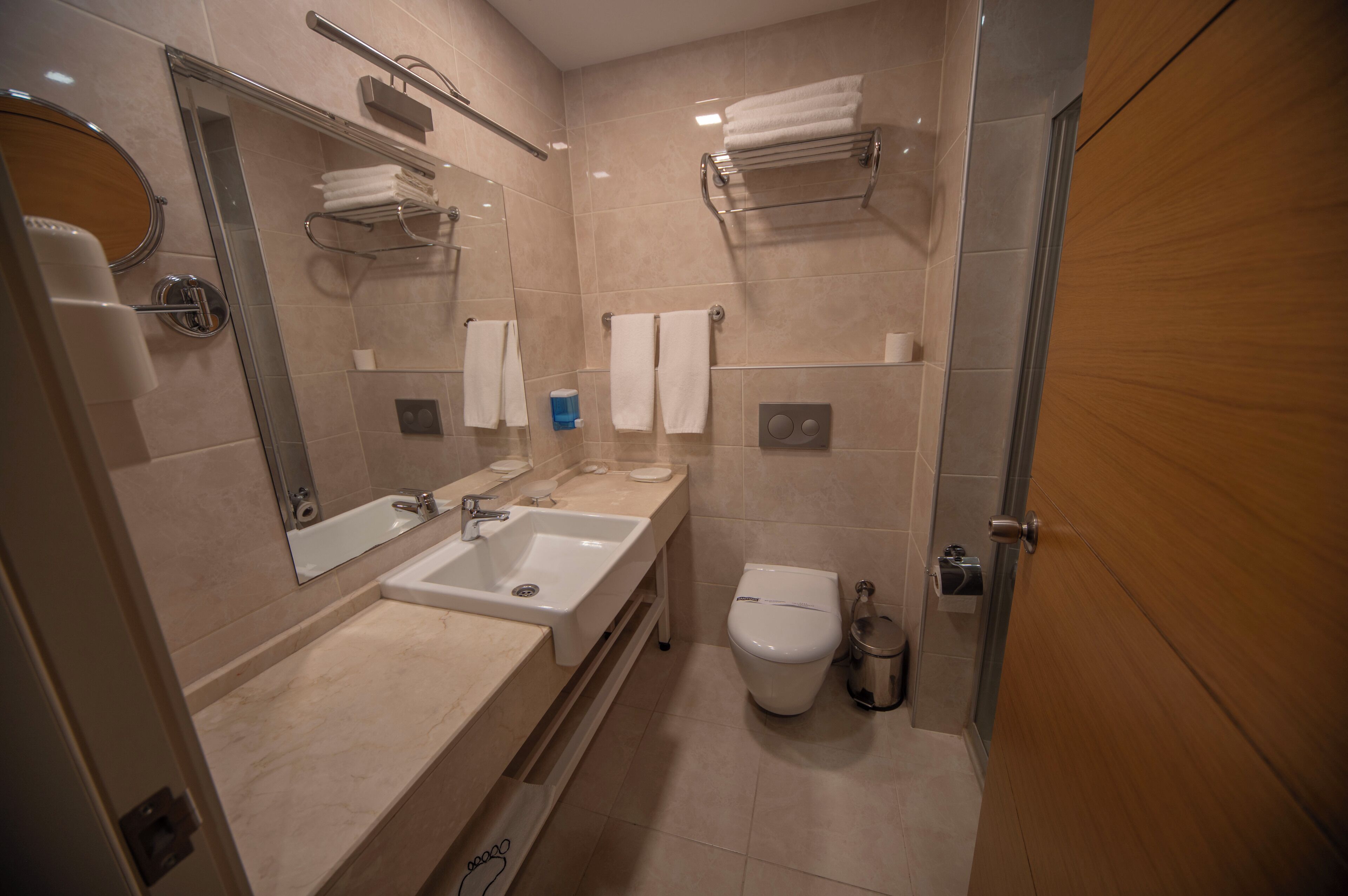 designer toiletries, hair dryer, slippers, towels