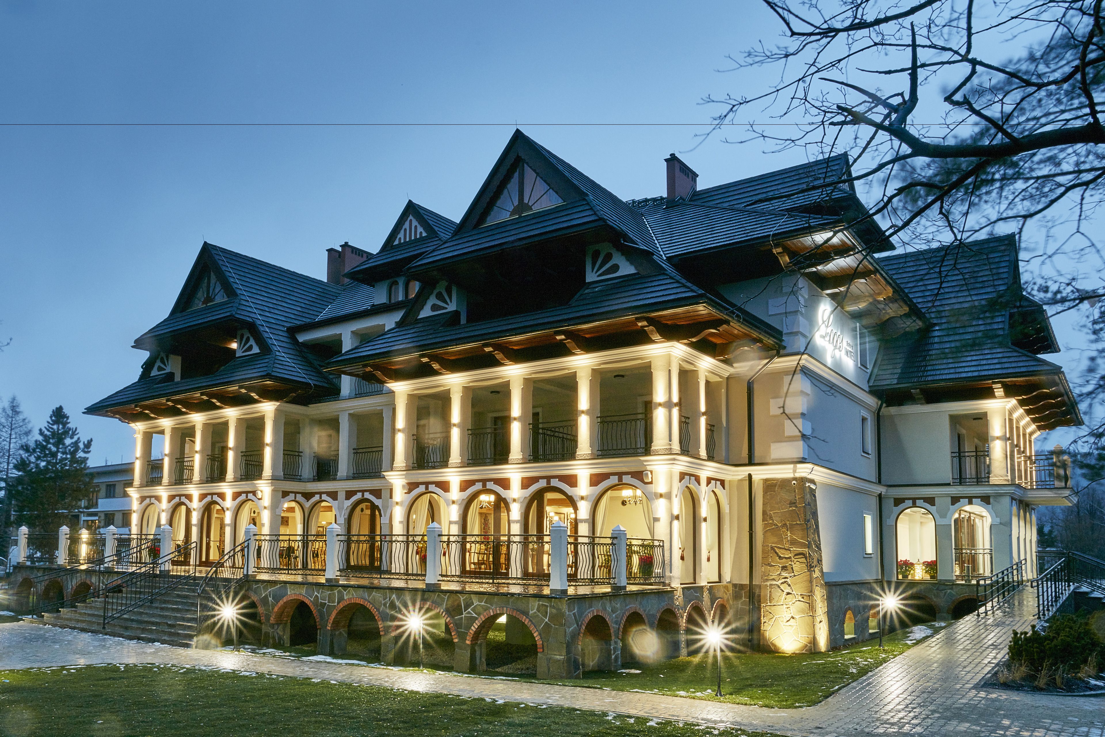 A large, multi-story building with a prominent balcony and stone archways.