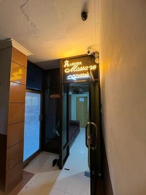 A hallway with a sign for 'Aurora Massaje Therapeia' indicating a spa or massage service. - Antares Medan (Medan)