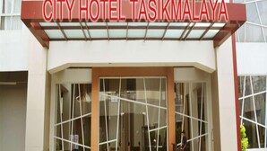 The exterior of City Hotel Tasikmalaya with a modern facade, large glass windows, and a prominent entrance. - City Hotel Tasikmalaya (Tasikmalaya)