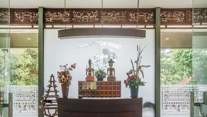A reception desk with a sign reading "Bali Kedaton Resort," surrounded by decorative items and a traditional wooden structure. - OYO 89999 Hotel Bumi Kedaton Resort (Bandar Lampung)