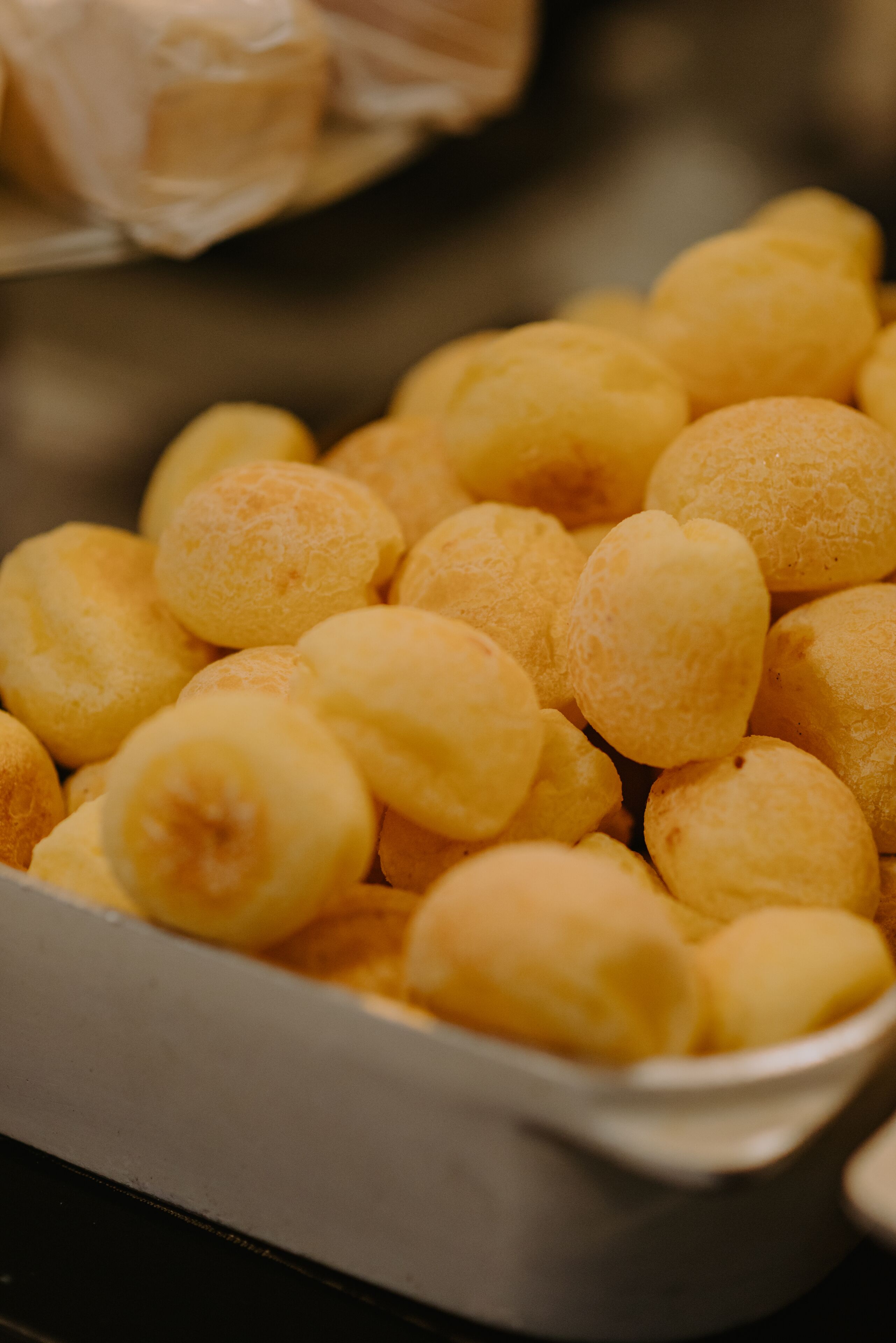 A tray of golden-brown pastries in a white container.