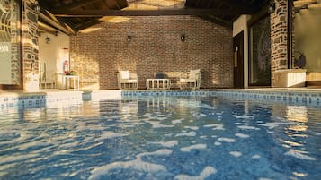 Indoor pool, pool umbrellas, pool loungers