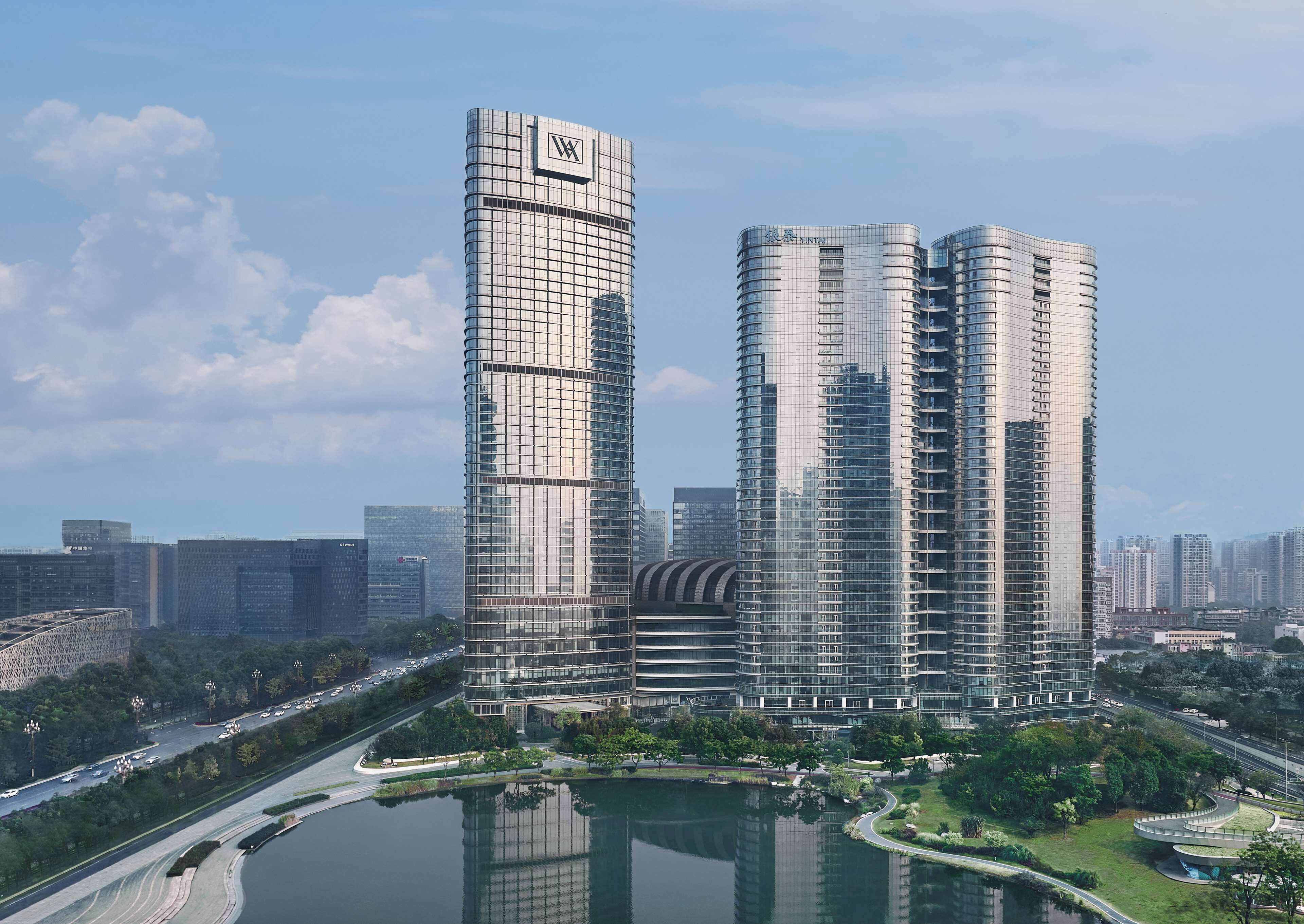 A modern high-rise building with a prominent 'W' logo on the top.