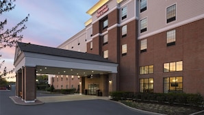 A Hampton Inn & Suites building with a brick facade, large windows, and a covered entrance area. - Hampton Inn & Suites Yonkers - Westchester (Yonkers)