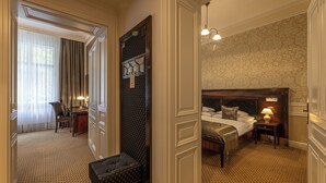 A hotel room with a large bed, bedside tables, a desk, and a chair. - Luxury Spa Hotel OLYMPIC PALACE (Karlovy Vary)