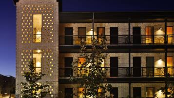 A multi-story building with a brick facade and multiple balconies.
