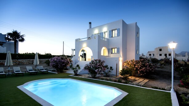 A modern villa with a swimming pool, outdoor seating, and well-maintained gardens. - Naxian Resort (Naxos)