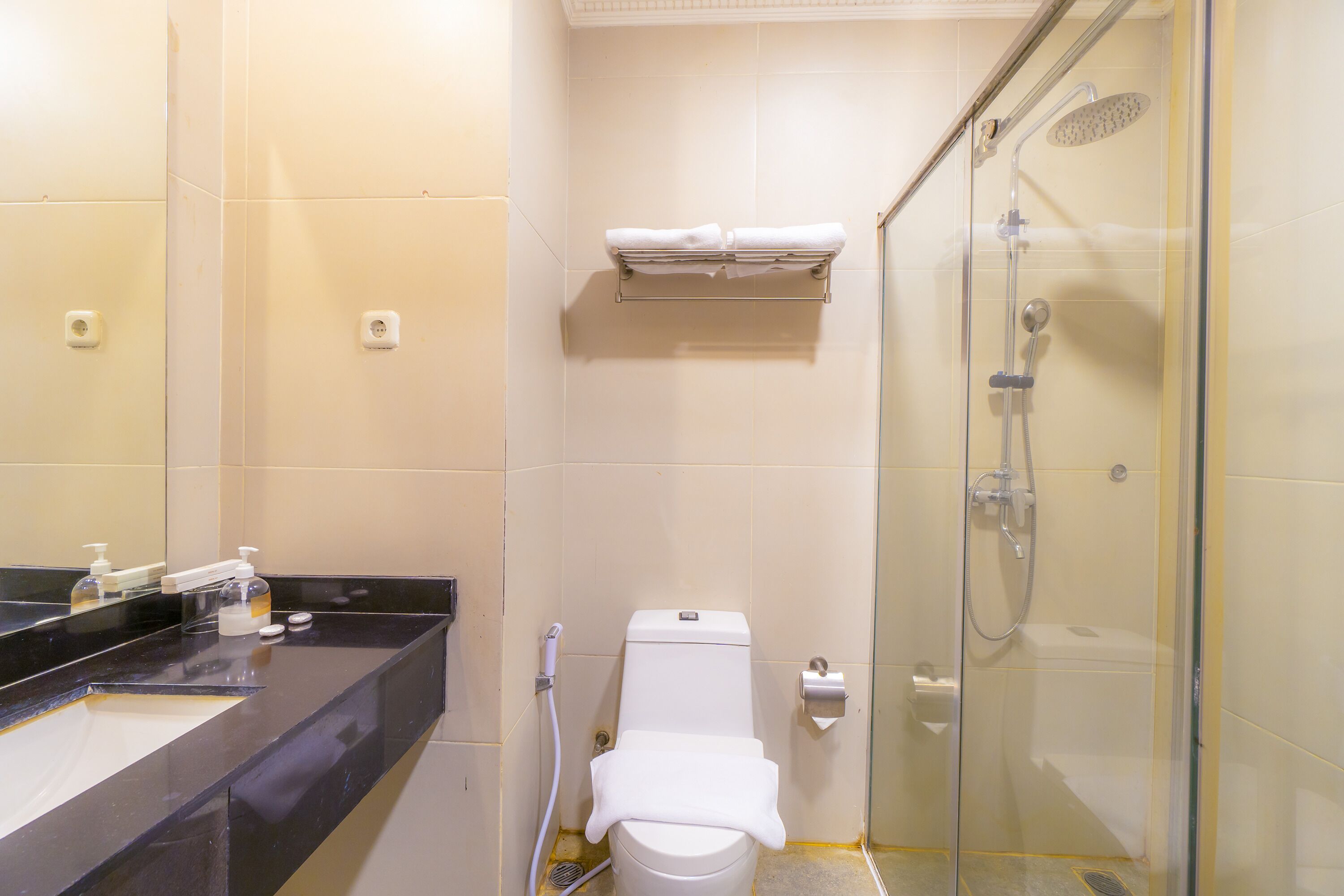 A bathroom with a toilet, sink, and shower.
