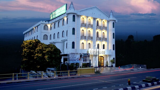 A large, white building with multiple balconies and a prominent sign for D'Salvatore Art & Boutique Hotel. - D'Salvatore Art & Boutique Hotel (Depok)