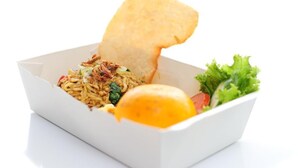 A takeout meal with noodles, fried items, a piece of bread, and a side of greens. - Swift Inn Aeropolis Airport (Tangerang)