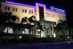 A hotel with a sign reading "Permata Hotel and Convention Center."