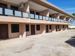 A multi-story hotel with a flat facade, large windows, and a concrete ground floor. - Hibiscus Residences Fiji (Nadi)