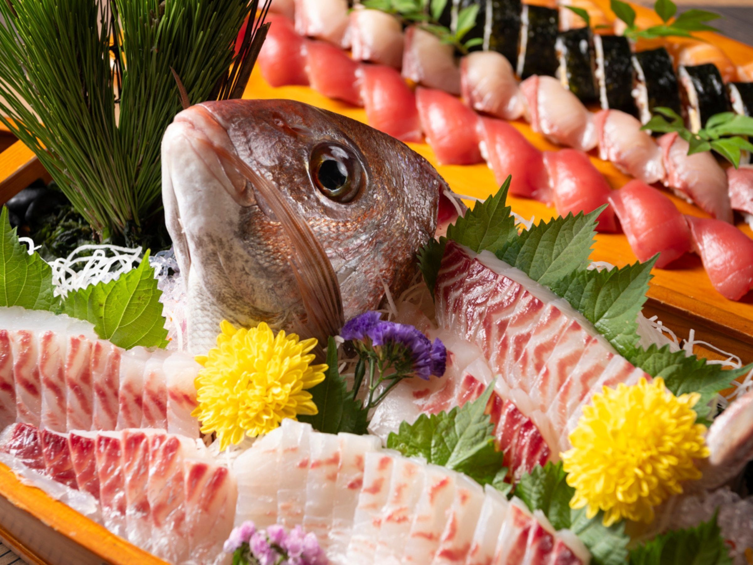 A variety of fresh seafood including fish and sushi on a wooden tray.