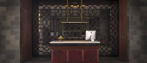 A reception desk with a modern design, a wooden frame, and a sign above that reads "AKANA".