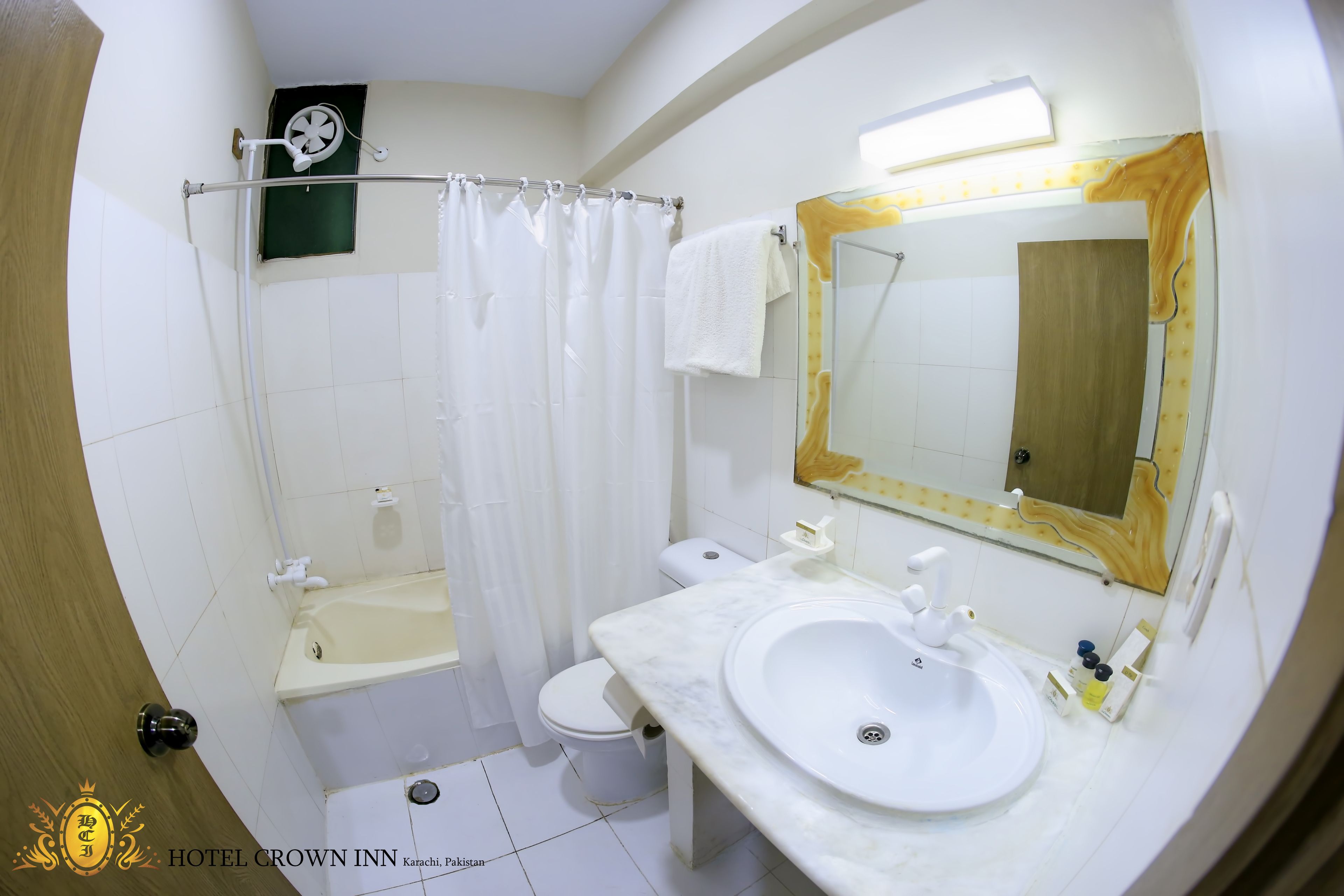 A bathroom with a bathtub, toilet, and sink.