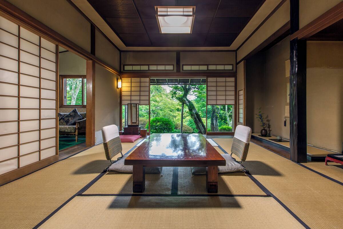 A traditional Japanese room with tatami flooring, a low table, and shoji screens.