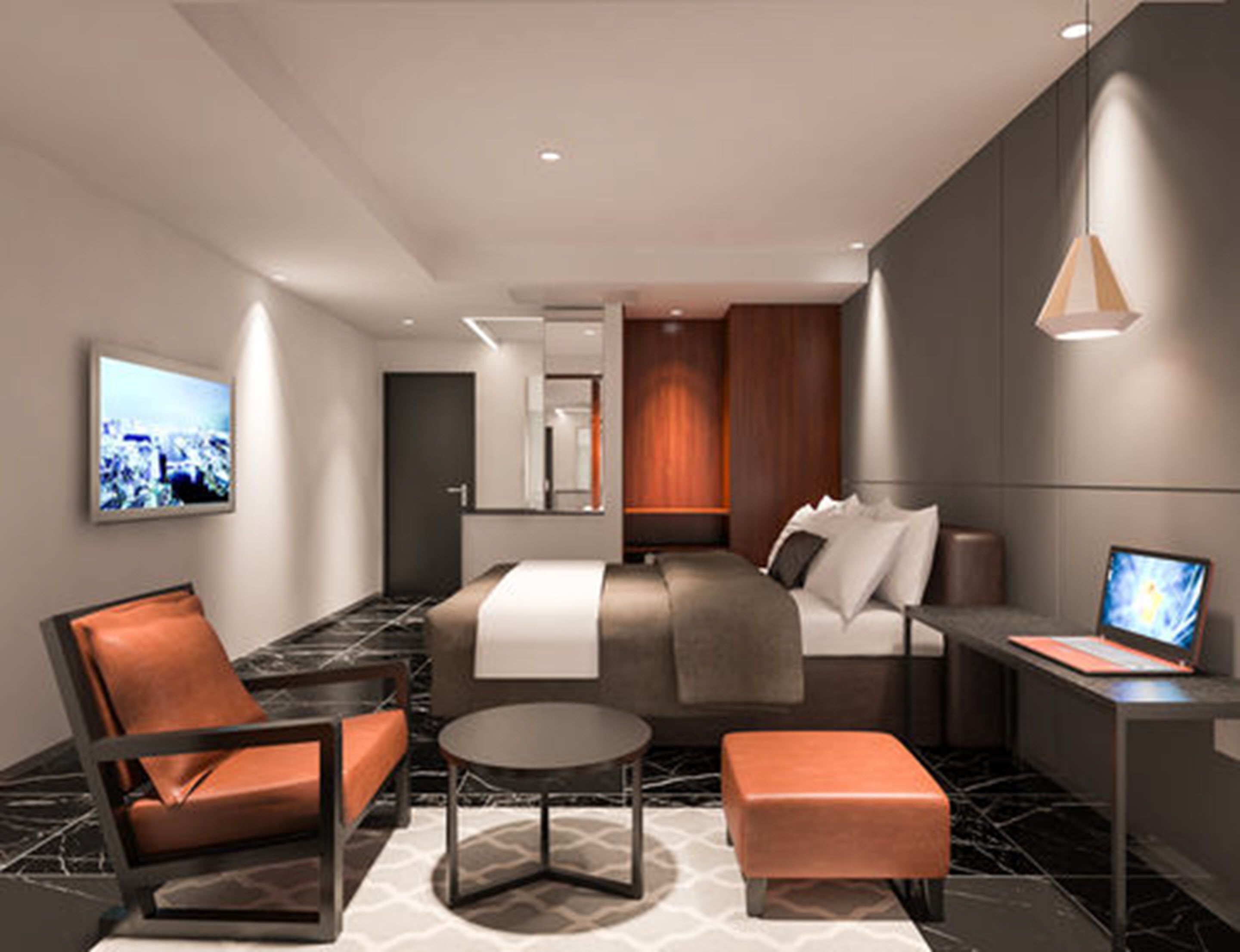 Et moderne hotelværelse med seng, skrivebord, stol og sofa.