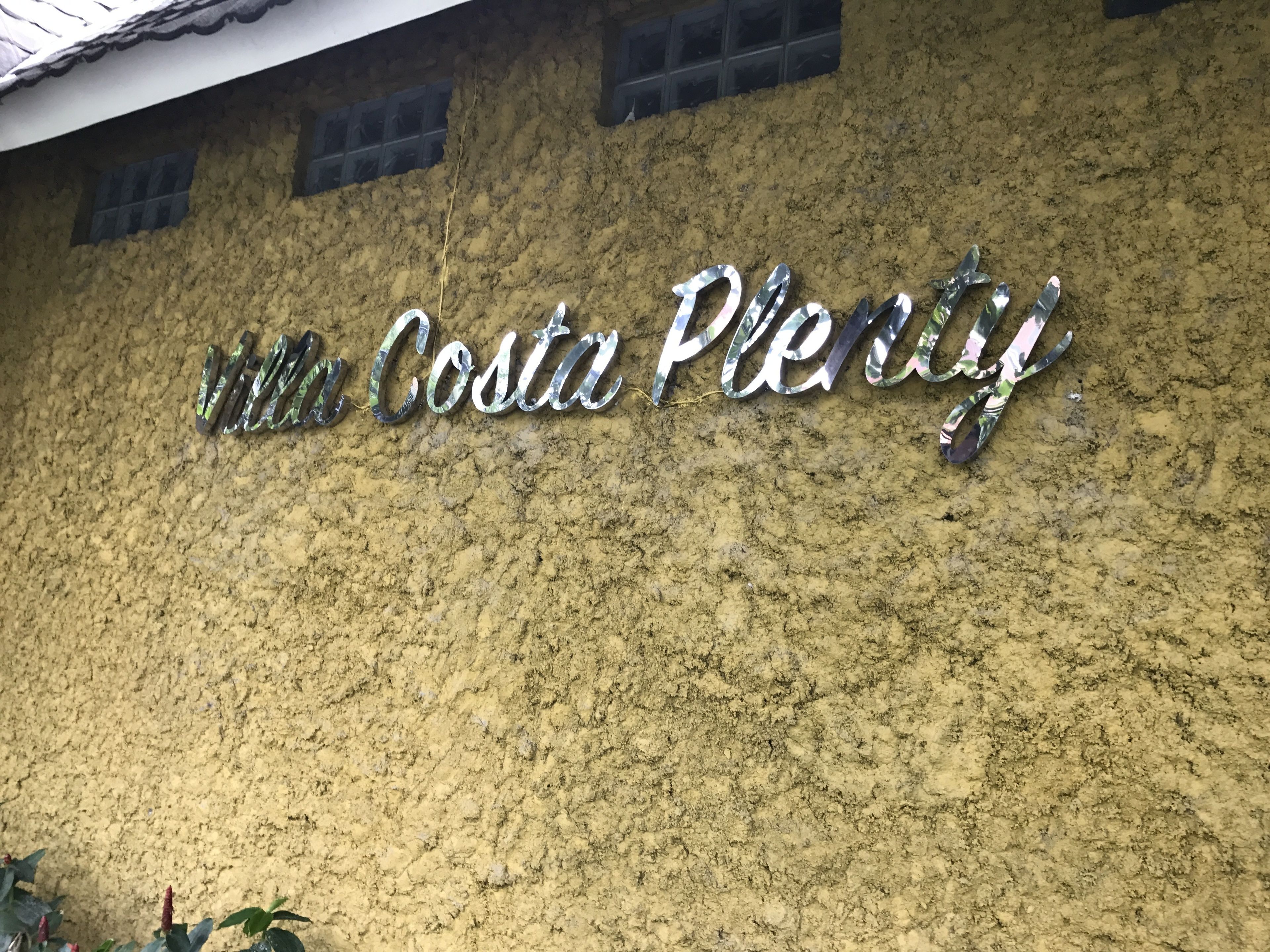 A building facade with the sign "Villa Costa Plentiful".