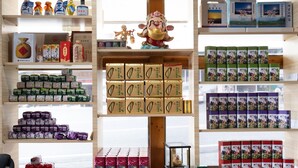 A store with shelves stocked with various packaged goods, including boxes and bottles. - Alishan Tea Homestay (Alishan)