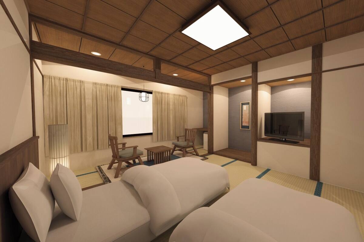 A hotel room with a large bed, a TV, a desk, and a chair.