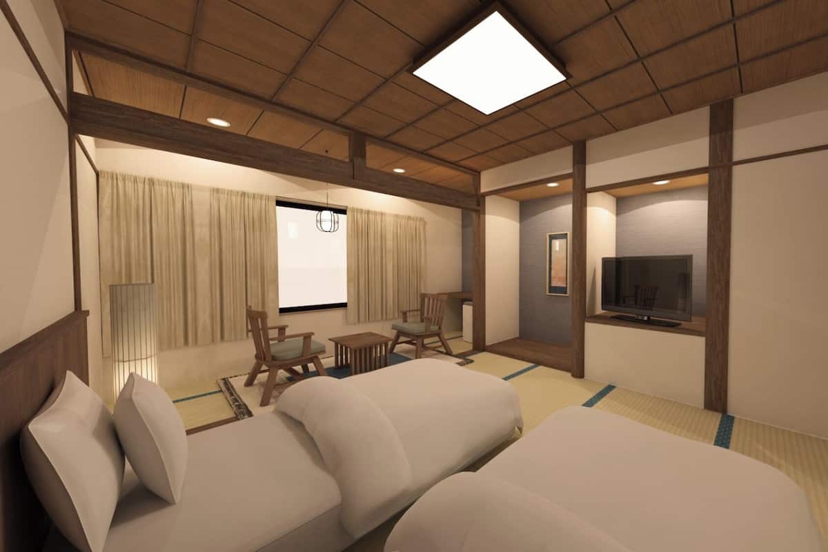 A hotel room with a large bed, a TV, a desk, and a chair.