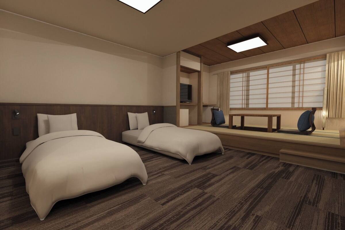 A hotel room with two beds, a TV, a window with blinds, and a wooden ceiling.
