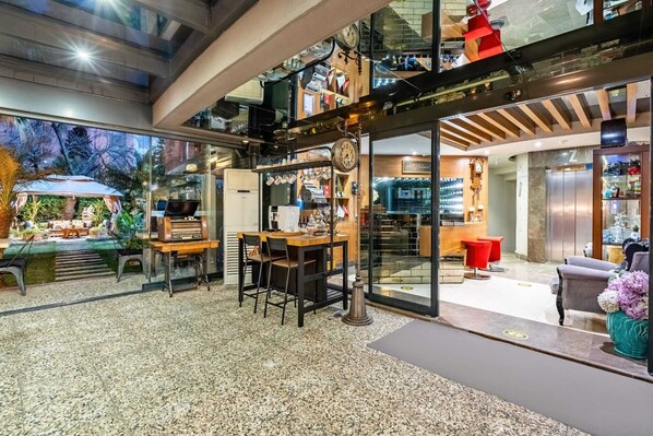 A modern interior with a dining area, kitchen, and a view of the outdoors.