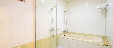 A bathroom with a shower, a bathtub, a toilet, and a towel rack.