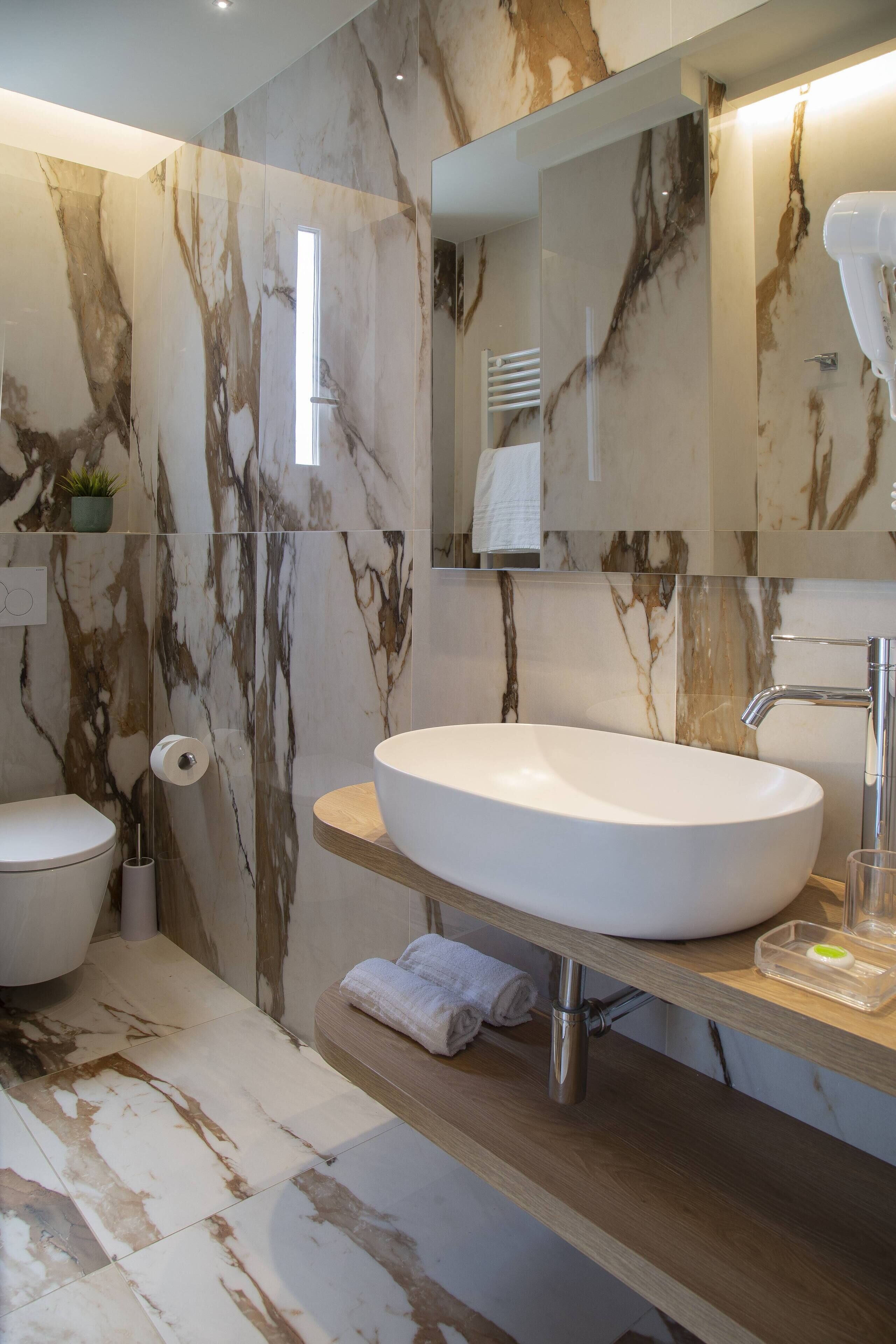 deluxe quadruple room, sea facing | bathroom | shower, free toiletries, hair dryer, bidet